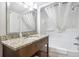 Bathroom featuring vanity with granite counters, sink, mirror, and bathtub with shower at 2000 N Ocean Blvd. # 1810, Myrtle Beach, SC 29577