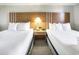 Cozy bedroom featuring two beds, night stand and lamps at 2000 N Ocean Blvd. # 1810, Myrtle Beach, SC 29577
