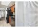 A cozy kitchen featuring dark appliances and wood cabinets, with view to the living area at 2000 N Ocean Blvd. # 1810, Myrtle Beach, SC 29577