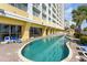 Outdoor pool surrounded by lounge chairs, showcasing a relaxing resort-style amenity with poolside building access at 2000 N Ocean Blvd. # 1810, Myrtle Beach, SC 29577