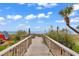 Picturesque boardwalk through lush dunes, leading to a stunning beachfront at 201 74Th Ave. N # 2534, Myrtle Beach, SC 29572