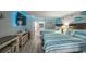 Bright bedroom with a TV, 2 beds, small kitchen and light blue accent lighting at 201 74Th Ave. N # 2534, Myrtle Beach, SC 29572