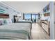 This bedroom features two queen beds, cool coastal decor and a sliding glass door to the patio at 201 74Th Ave. N # 2534, Myrtle Beach, SC 29572