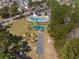 Community aerial showcasing the pool, tennis court, bocce ball court and green space near single-Gathering homes at 203 Old Hickory Dr., Conway, SC 29526
