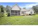 Well-maintained backyard featuring a patio, screened-in porch, lush lawn, and manicured landscaping at 203 Old Hickory Dr., Conway, SC 29526
