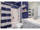 Cozy bathroom with navy blue walls, a shower-tub combination with stylish curtain, and floating shelves at 203 Old Hickory Dr., Conway, SC 29526