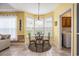 Cozy dining area with a round table, four chairs, lots of natural light, and a view to the outside at 203 Old Hickory Dr., Conway, SC 29526