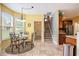 Sunlit dining area features a round table, four chairs, and a view of the outside; convenient access to kitchen and stairs at 203 Old Hickory Dr., Conway, SC 29526