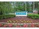 Neighborhood entrance sign with mature landscaping featuring a variety of colorful plants and shrubbery at 203 Old Hickory Dr., Conway, SC 29526