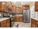 Well-equipped kitchen with stainless steel appliances, wood cabinetry, granite countertops, and tiled backsplash at 203 Old Hickory Dr., Conway, SC 29526
