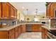 Spacious kitchen with wooden cabinets, stainless steel appliances, granite countertops, and a cozy eat-in area at 203 Old Hickory Dr., Conway, SC 29526