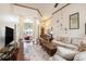 Open living area with high ceilings, hardwood floors, comfortable sofas, and decor, bathed in natural light at 203 Old Hickory Dr., Conway, SC 29526