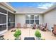 Charming patio with comfortable seating and potted plants; ideal for relaxing and enjoying the outdoors at 203 Old Hickory Dr., Conway, SC 29526