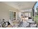 Inviting screened-in patio with comfortable seating, ceiling fan, and view of the landscaped yard at 203 Old Hickory Dr., Conway, SC 29526