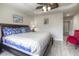 Well-lit bedroom featuring a large bed with colorful pillows, light flooring, and a cozy red chair at 2180 Waterview Dr. # 738, North Myrtle Beach, SC 29582
