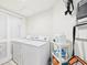 Bright laundry room with washer, dryer, storage shelving, and closet at 2180 Waterview Dr. # 738, North Myrtle Beach, SC 29582