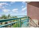 Balcony view of the beach and pool with tropical palm trees from this beautiful condo at 2207 S Ocean Blvd. # 718, Myrtle Beach, SC 29577