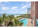Ocean views from an inviting pool area with lounge chairs, palm trees, and beach access at 2207 S Ocean Blvd. # 718, Myrtle Beach, SC 29577