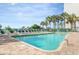 The clear blue pool, surrounded by palm trees and lounge chairs, offers ocean views at 2207 S Ocean Blvd. # 718, Myrtle Beach, SC 29577