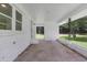Covered back porch with painted brick and columns overlooking the grassy lawn at 265 Powell Loop, Andrews, SC 29510