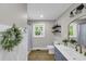 Charming bathroom with blue vanity, wood-look tile flooring, and modern fixtures at 265 Powell Loop, Andrews, SC 29510