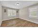 Bright bedroom featuring hardwood floors and two windows for ample natural light at 265 Powell Loop, Andrews, SC 29510