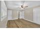 Bedroom with ceiling fan, hardwood floors, and a connected bathroom with a door at 265 Powell Loop, Andrews, SC 29510