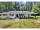 Charming single-story white brick home featuring a well-manicured lawn and cozy front porch at 265 Powell Loop, Andrews, SC 29510
