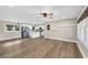 Open-concept living space featuring hardwood floors, white kitchen cabinets, stainless steel appliances and ample natural light at 265 Powell Loop, Andrews, SC 29510