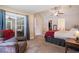 Spacious bedroom features a sliding glass door to a sunroom, chair, and ensuite bathroom at 276 Avery Dr., Myrtle Beach, SC 29588