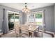Elegant dining room with a stylish chandelier, sliding glass door to the backyard, and seating for six at 276 Avery Dr., Myrtle Beach, SC 29588