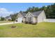 Well-maintained home with light siding, a manicured lawn, and mature trees for added privacy at 276 Avery Dr., Myrtle Beach, SC 29588