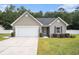 Charming single-story home featuring stone accents, a manicured lawn, and an attached two-car garage at 276 Avery Dr., Myrtle Beach, SC 29588