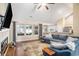 Bright living room open to the dining area, featuring hardwood floors, a large sofa, and many windows at 276 Avery Dr., Myrtle Beach, SC 29588