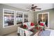 Inviting screened-in patio area with comfortable seating, ceiling fan, and natural light, perfect for relaxation and entertaining at 276 Avery Dr., Myrtle Beach, SC 29588