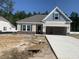 Charming single-story home featuring a neutral color palette, attached garage, and well-lit front entrance at 292 Palmetto Sand Loop, Conway, SC 29527
