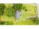 Aerial view of a property with a fenced backyard, mature trees, and a driveway with a car at 2965 Mount Olive Rd., Loris, SC 29569