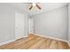 Bedroom featuring neutral walls, light wood laminate flooring, ceiling fan and a closet at 2965 Mount Olive Rd., Loris, SC 29569