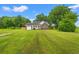 Well maintained brick home with a lush green lawn and mature trees on a sunny day at 2965 Mount Olive Rd., Loris, SC 29569
