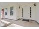 Covered front porch with white pillars, windows, and house number above the front door at 2965 Mount Olive Rd., Loris, SC 29569
