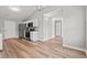 Bright kitchen features stainless steel appliances, white cabinets, and wood-look flooring at 2965 Mount Olive Rd., Loris, SC 29569