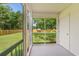Screened-in back porch with a view of the lawn and a wooden fence in the background at 2965 Mount Olive Rd., Loris, SC 29569