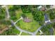 Aerial view of the property showcasing lush landscaping, a long driveway, and a private backyard with a pool at 300 Crescent Dr., Conway, SC 29526