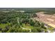Expansive aerial view of a single-story home nestled on a spacious lot with mature trees and green lawns at 300 Crescent Dr., Conway, SC 29526
