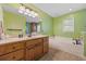 Bright bathroom with a soaking tub, vanity with ample storage, and tiled floor at 300 Crescent Dr., Conway, SC 29526