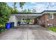 Spacious brick carport with access to a backyard patio area with seating and a grill at 300 Crescent Dr., Conway, SC 29526