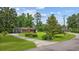 Charming single-story home surrounded by lush greenery and a well-manicured lawn at 300 Crescent Dr., Conway, SC 29526
