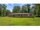 Traditional brick home features a well-manicured lawn and black shutters, exuding classic charm at 300 Crescent Dr., Conway, SC 29526