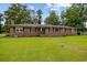 Traditional brick ranch-style home with black shutters, lush lawn, and inviting walkway at 300 Crescent Dr., Conway, SC 29526