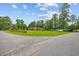 Charming brick home with lush green lawn and mature trees, creating a picturesque setting at 300 Crescent Dr., Conway, SC 29526